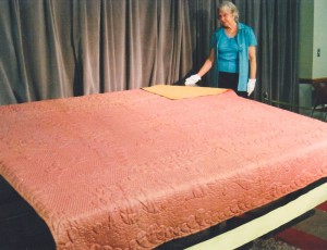 The Martha Howard Quilt in a rare public appearance and closely watched by Lorraine Hatch (Courtesy of the Canton Historical Society)