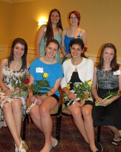 Gold Award recipients Alicia Healy and Emily Buckley (holding yellow roses) with fellow Canton Girl Scouts
