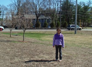 Sanjana Deshpande, a third grader from the JFK School, stands approximately where the new dogwood tree will be planted on Arbor Day.