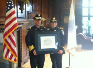 Chief Ken Berkowitz and Lt. Patty Sherrill hold the certification document from the Mass. Police Accreditation Commission.