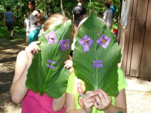 Green Up participants show off their leaf masks. (Friends of the Blue Hills photo)