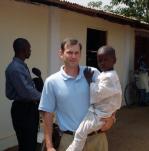 Phil d'Entremont with a child at the NHI Children's Home