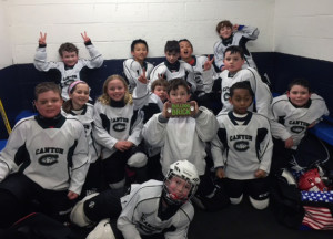 Members of the Mite C White team celebrate their championship victory.