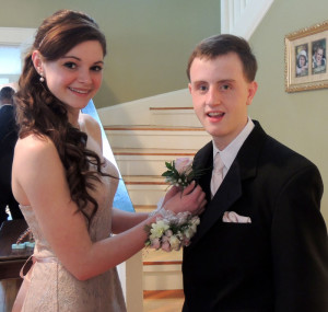 Kaitlin McCarthy pins a boutonniere on her prom date, Matty Marcone. (Moira Sweetland photo)