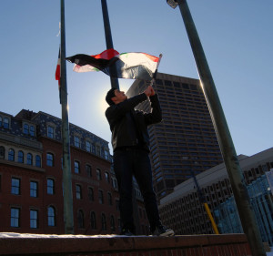 Matthew waves the Syrian flag during a demonstration in Boston last winter.