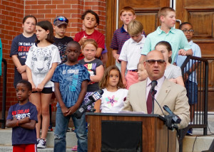 Police Chief Ken Berkowitz shares remarks with the crowd. The children were invited to stand on the steps during the vigil. (Michelle Stark photo)