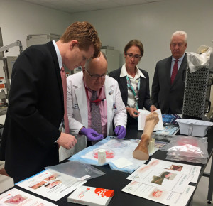 U.S. Rep. Joe Kennedy III (far left) receives an up-close look at the wound-care advances at Canton-based Organogenesis.