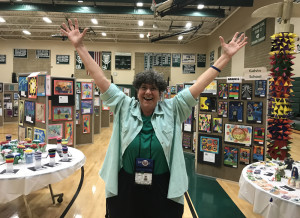 An exuberant Joyce Stenmon poses for a photo during her last PreK-12 Visual Arts Show in May. (Ed McDonough photo)