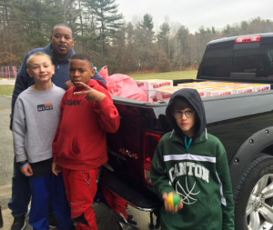 L-R: Students Anthony Viau, Djouby Alice and Dylan Roach help Mr. Adams load the truck with supplies.